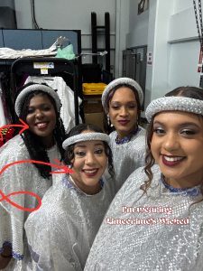 Four women wearing red lipstick in costumes for a production. Displaying red lips.